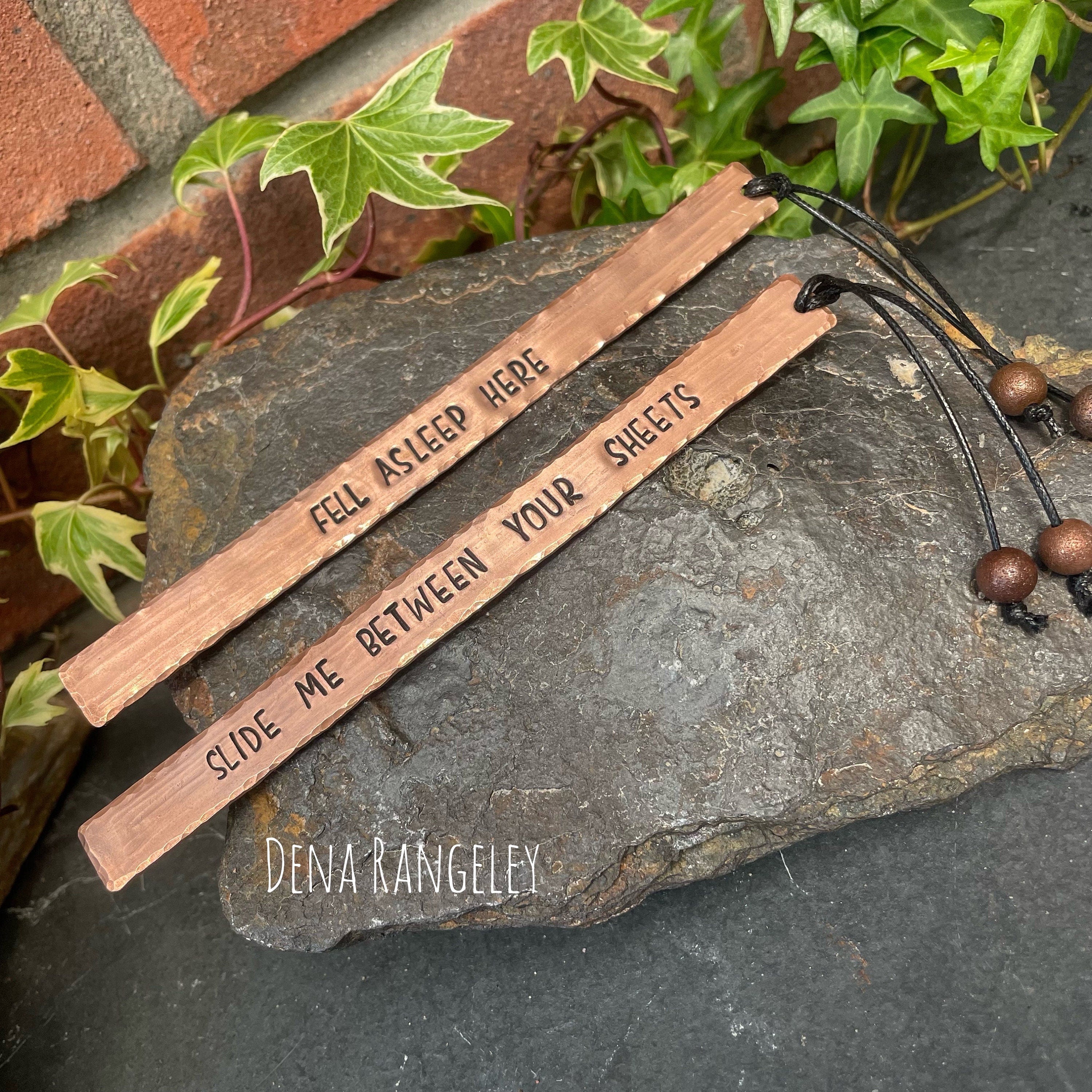 Copper bookmarks. Stamped bookmark. Fell asleep here. Between the sheets. A book is a dream. Just one more chapter.