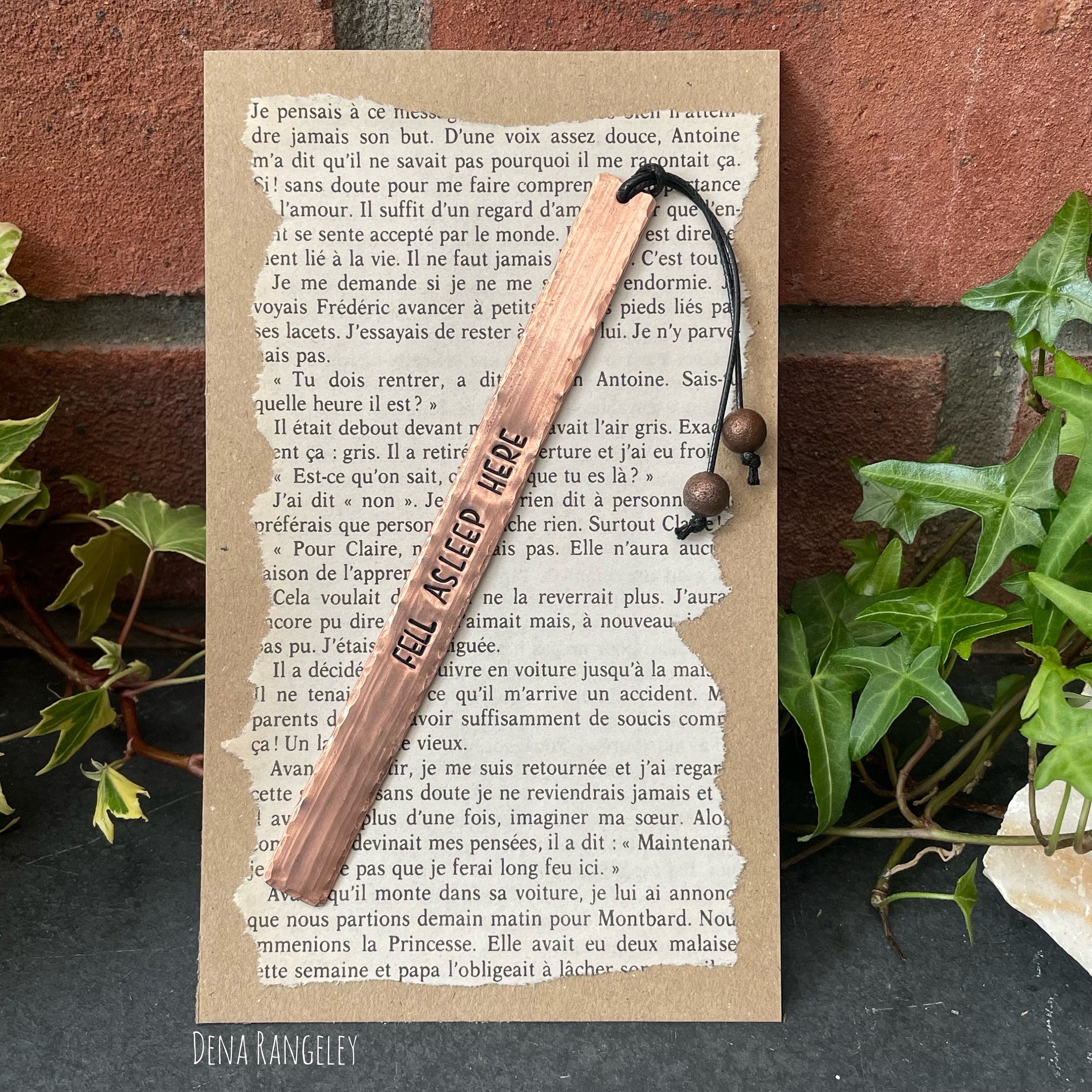 Copper bookmarks. Stamped bookmark. Fell asleep here. Between the sheets. A book is a dream. Just one more chapter.