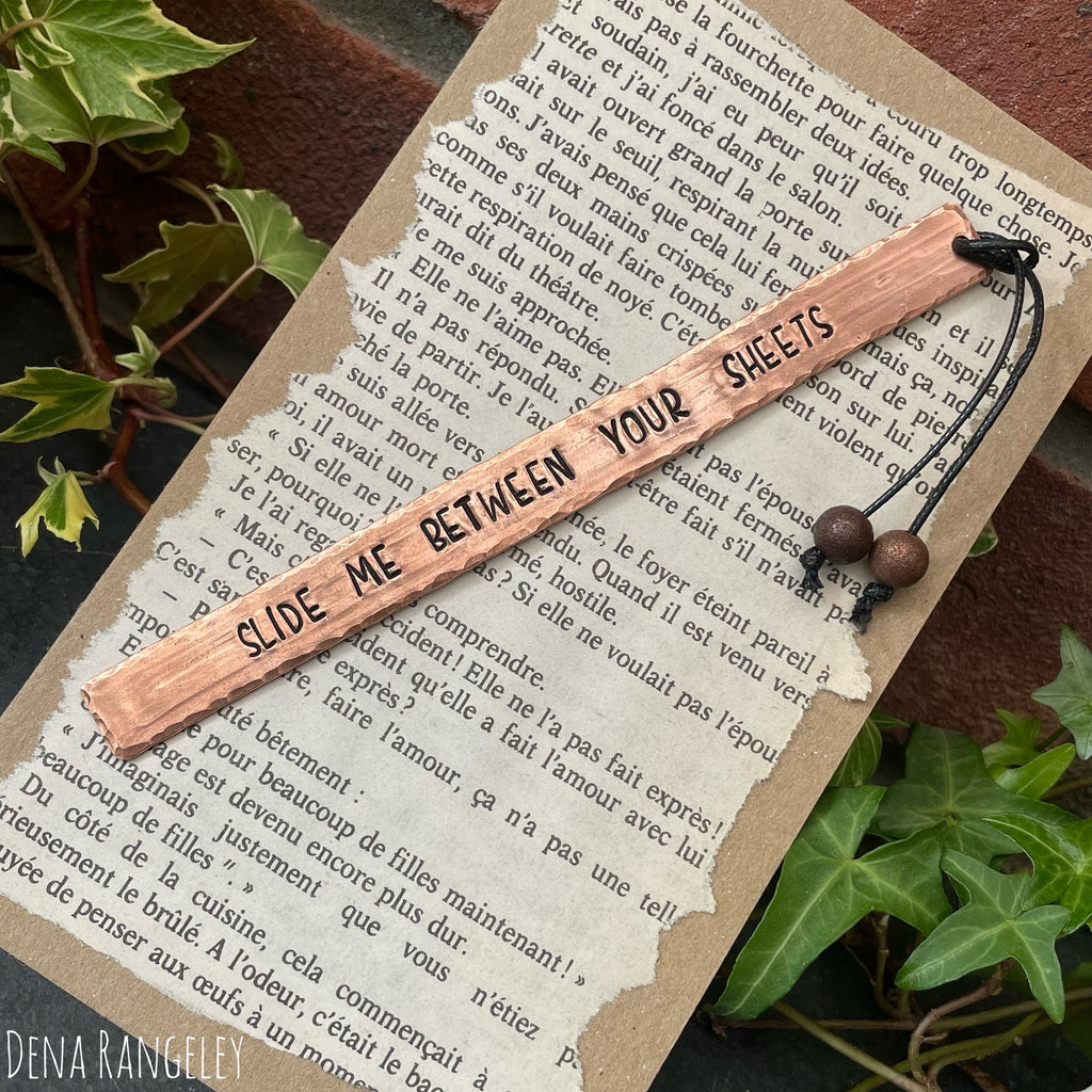 Copper bookmarks. Stamped bookmark. Fell asleep here. Between the sheets. A book is a dream. Just one more chapter.
